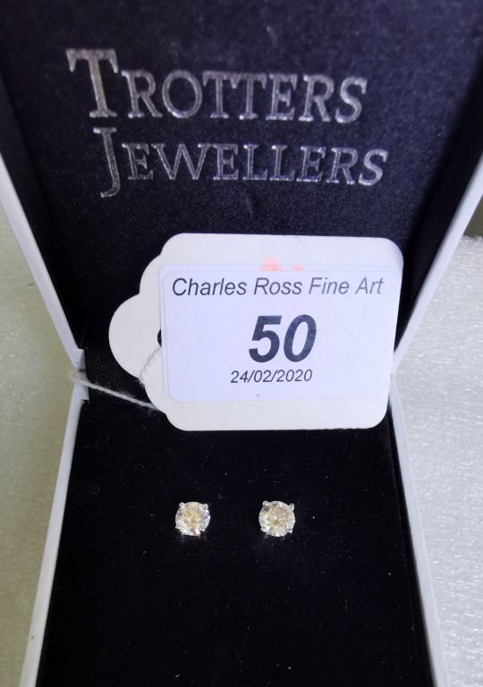 A pair or single stone diamond earrings, the brilliant cut diamonds in four claw mounts, marked 14k,