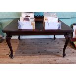 An early 20th century mahogany square topped screw extending dining table,