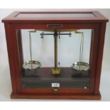 A glass and wood cased set of Griffin & George weighing scales.