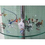 A collection of assorted small glass animal figures, to include: sausage dog, parrot on perch,