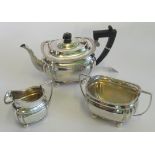 A hallmarked silver three piece tea set, comprising: teapot, milk jug and sugar bowl,