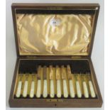 A cased set of hallmarked silver fruit knives and fork's with mother of pearl effect handles,