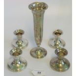 Four silver squat candlesticks with weighted bases marked Birks Sterling,