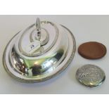 A sterling silver compact, with decoration decoration of a young boy feeding an elephant to front,