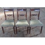 A collection of three matching Regency mahogany side chairs, with pierced splats and brass inlay.