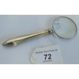 A hallmarked silver magnifying glass.