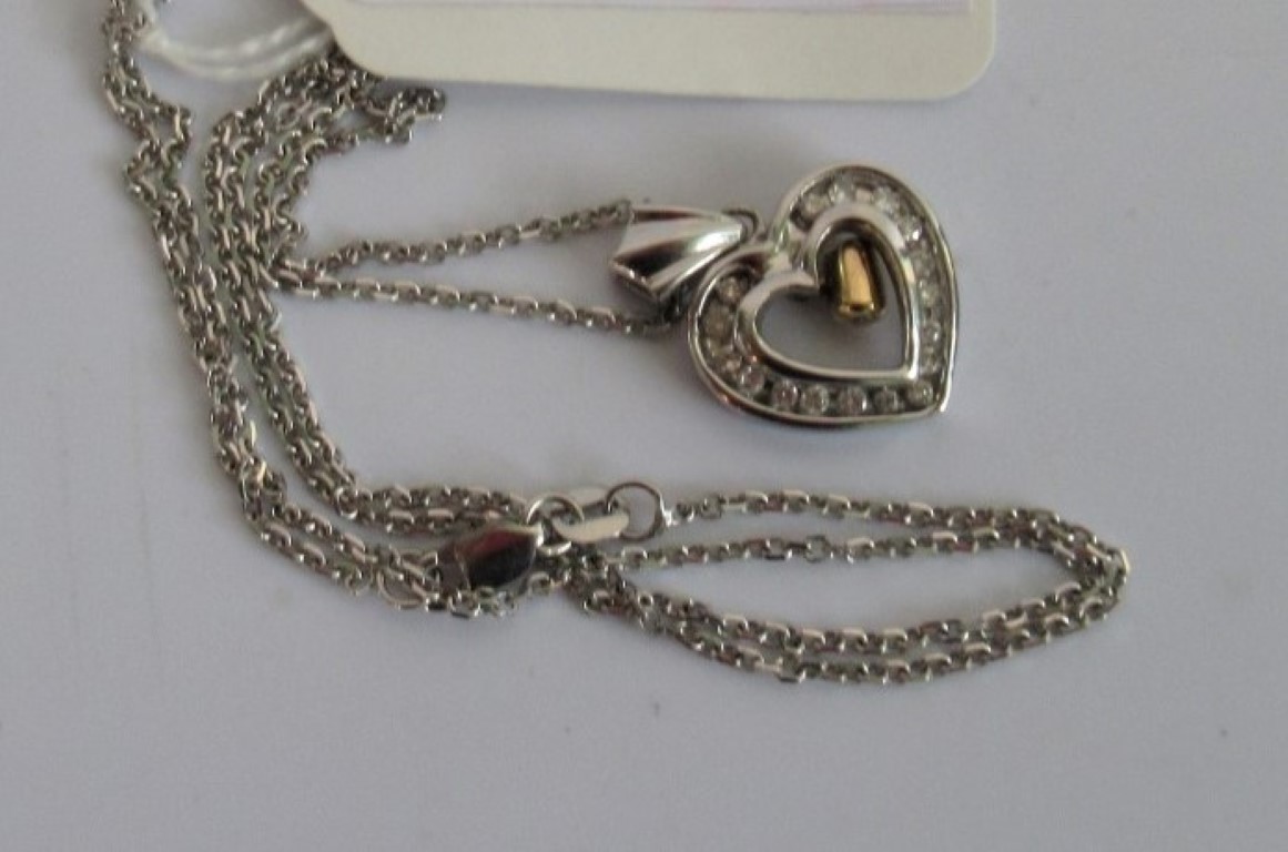 A diamond set heart shaped pendant, the