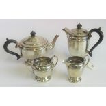 A hallmarked silver four piece tea set, comprising: sugar bowl, milk jug, teapot and coffee pot,