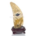 Ø AN UNUSUAL SCRIMSHAW DECORATED WHALE'S TOOTH
