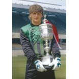 Football Autographed 12 x 8 photo, a superb image depicting JOHN LUKIC posing with the League Cup