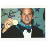 Steve Redgrave signed 10x8 colour photo pictured holding up one of his five gold medals he won in