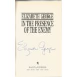 Elizabeth George signed In the presence of the enemy hardback book. Signed on inside title page.