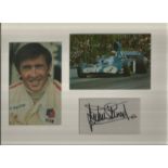Jackie Stewart signature piece mounted below colour photo of him racing and alongside colour