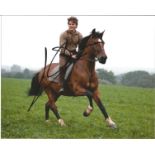 Jeremy Irvine signed 10x8 colour photo action shot riding a horse. Good Condition. All autographs
