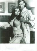 James Bond Madeline Smith signed 10 x 8 b/w photo standing with Roger Moore. Good Condition. All