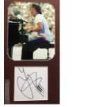 Jamie Cullum autograph mounted with colour photo in concert to an overall size of 18 x 11 inches.