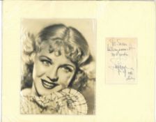 Ginger Rogers signature piece alongside a vintage photo. Mounted. Slight crease mark to signature