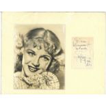 Ginger Rogers signature piece alongside a vintage photo. Mounted. Slight crease mark to signature