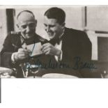 Space and Rocket pioneer Wernher Von Braun signed 5 x 3 b/w photo sitting with a General looking