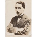 Charles Chaplin signed 7 x 5 sepia portrait photo of a young Chaplin with bow tie and tense look.