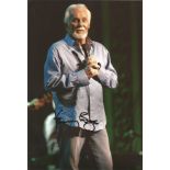 Kenny Rogers signed 12x8 colour photo. Good Condition. We combine postage on multiple winning lots