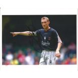 Sami Hyypia signed 10x8 colour photo captaining Liverpool. Good Condition. We combine postage on