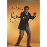 Roger Moore signed 12x8 colour photo. Dedicated. Good Condition. We combine postage on multiple