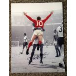 Geoff Hurst signed 16x12 colourised celebratory 1966 photo. Good Condition. We combine postage on