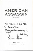 Vince Flynn (the author) signed paperback American Assassin with inscription to John. Advance