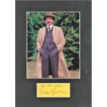 Philip Jackson signature piece below colour photo from Poirot. Mounted to Approx. size 16x12. Good