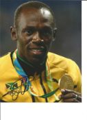 Athletics Usain Bolt signed 10x8 signed colour photo pictured with Olympic Gold Medal at the 2012