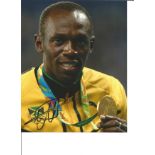 Athletics Usain Bolt signed 10x8 signed colour photo pictured with Olympic Gold Medal at the 2012