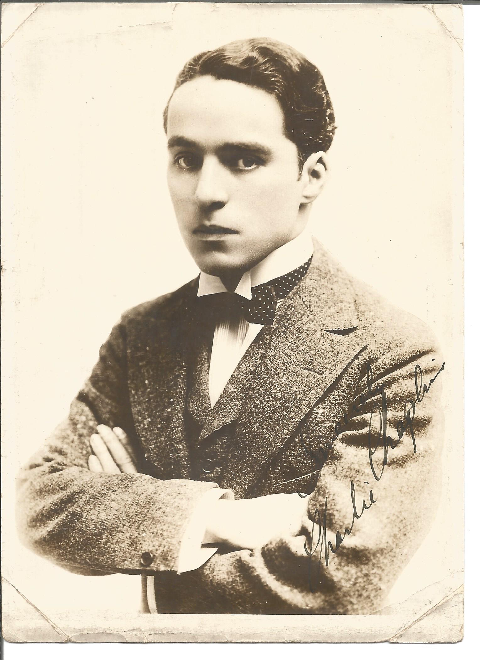 Charles Chaplin signed 7 x 5 sepia portrait photo of a young Chaplin with bow tie and tense look.