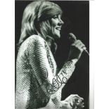 Cilla Black signed 12 x 8 b/w photo singing on stage. Good Condition. All signed pieces come with