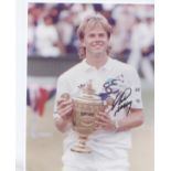 Stefan Edberg signed 10 x 8 inch photo holding the Wimbledon Trophy after one of his famous