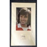 George Best signature piece mounted below colour photo. Approx overall size 21x12. Good Condition.