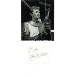 Charlton Heston signature piece mounted below black and white photo. Approx overall size 18x12. Good