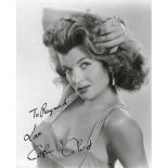 Corinne Calvet Signed 10 x 8 inch b/w sexy portrait photo To Raymond. Condition 8/10. All autographs