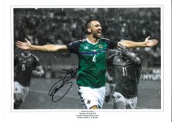 Gareth McCauley Northern Ireland Signed 16 x 12 inch football photo. . All autographs are genuine