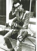 Elvis Costello signed 12 x 8 inch b/w music photo. All autographs are genuine hand signed and come