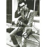 Elvis Costello signed 12 x 8 inch b/w music photo. All autographs are genuine hand signed and come