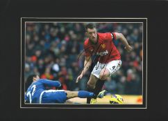 Phil Jones signed 16x12 mounted colour photo pictured in action for Manchester United. Philip