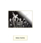 Bobby Charlton signed 10x10 mounted black and white photo pictured lifting the European Cup for