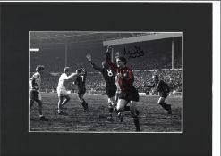 Mike Doyle signed 16x12 overall mounted colourised photo pictured in action for Manchester City.