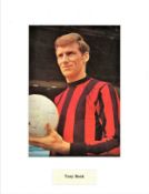 Tony Book signed 14x11 mounted colour photo pictured during his playing days with Manchester City.