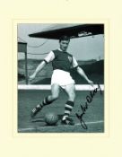 Jimmy McIlroy signed 14x11 mounted black and white photo pictured during his playing days with