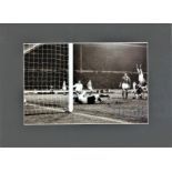 Colin Bell signed 16x12 overall mounted black and white photo pictured in action for England against