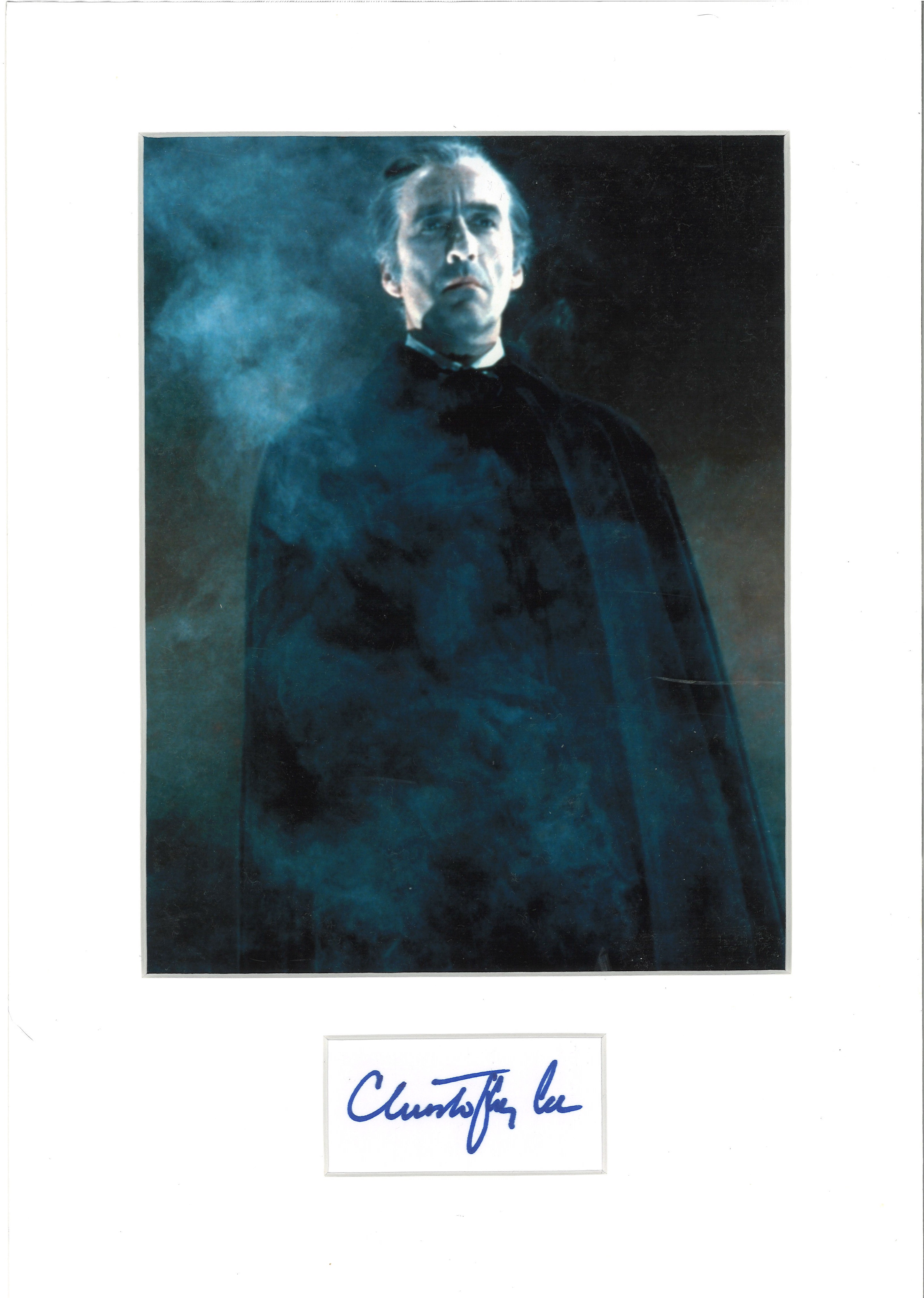 Christopher Lee signature piece mounted below colour photo. Approx overall size 16x12. Good