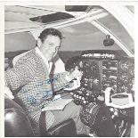 Cliff Robertson signed 8 x 8 inch b/w photo at controls of aircraft in cockpit. Good Condition.