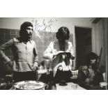 Rolling Stones Charlie Watts signed 12 x 8 inch b/w relaxed band photo in kitchen. Good Condition.